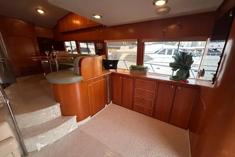 Slide: The Image of Luxurious interior of a 1999 Mikelson 64 Long Range Sportfish yacht with elegant wood finishes. - 7