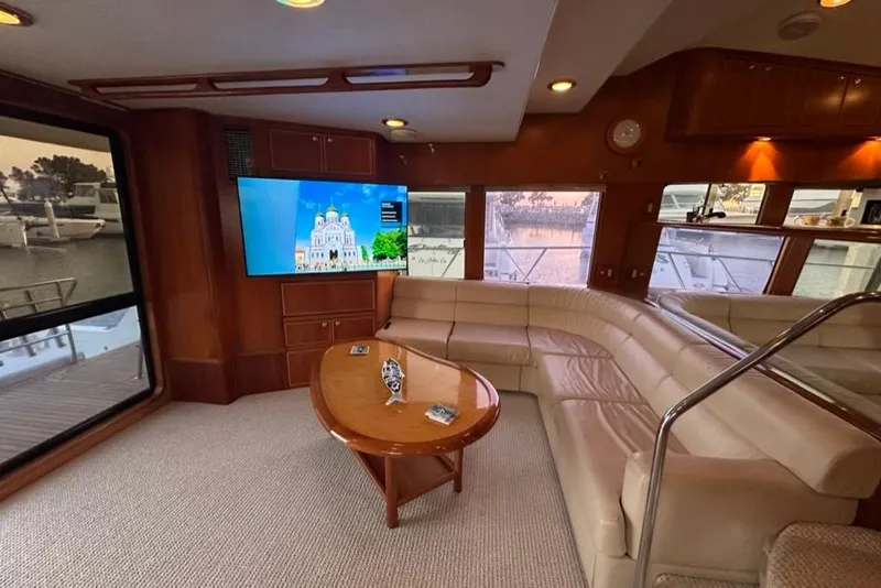 Slide: The Image of Luxurious interior of 1999 Mikelson 64 yacht with plush seating and large windows. - 9