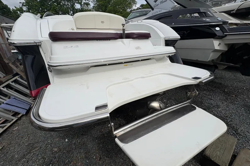 Slide: The Image of 2013 Cobalt 242 boat rear view with swim platform and ladder. - 14