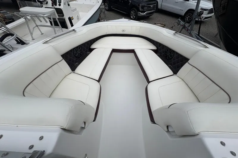 Slide: The Image of Luxurious seating area on a 2013 Cobalt 242 boat, featuring white upholstery. - 4