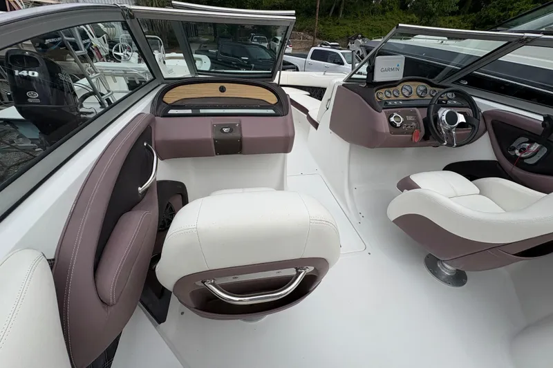 Slide: The Image of Interior of a 2013 Cobalt 242 boat featuring plush seating and modern dashboard controls. - 8