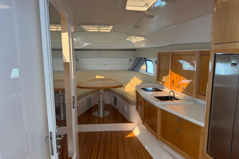 Slide: The Image of Interior of 2017 Intrepid 475 Sport Yacht with modern kitchen and seating area. - 15