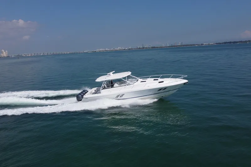 Slide: The Image of 2017 Intrepid 475 Sport Yacht cruising on open water under clear skies. - 8