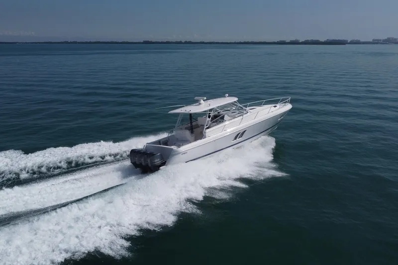 Slide: The Image of 2017 Intrepid 475 Sport Yacht cruising on open water, showcasing sleek design and powerful engines. - 9