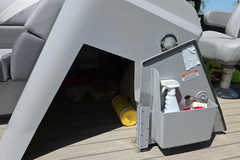 Slide: The Image of Storage compartment on a 2020 Bennington SX 22 SSLDX boat with cleaning supplies. - 15