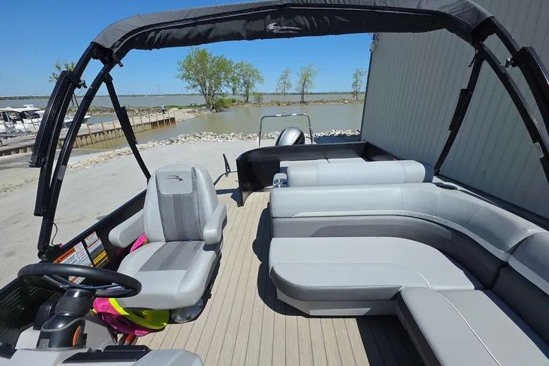 Slide: The Image of 2020 Bennington SX 22 SSLDX pontoon boat interior with gray seating and steering wheel. - 16