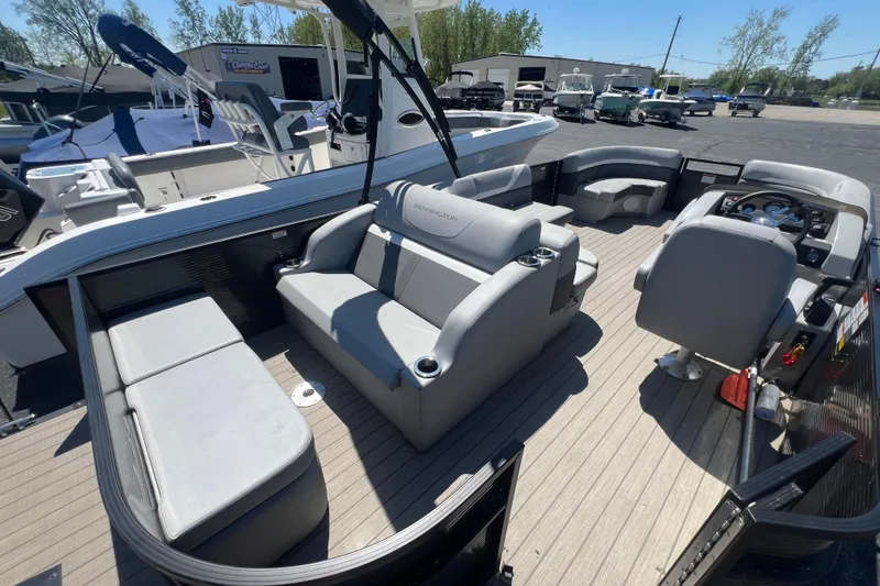 Slide: The Image of 2020 Bennington SX 22 SSLDX pontoon boat interior with gray seating and helm. - 20