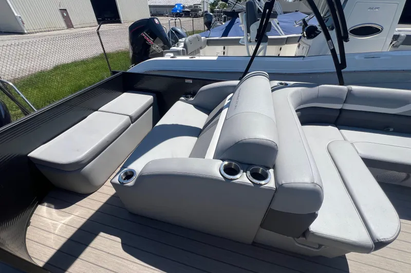 Slide: The Image of 2020 Bennington SX 22 SSLDX pontoon boat interior with gray seating and cup holders. - 21