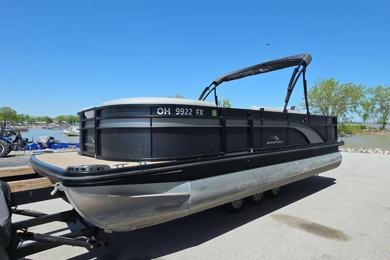 Slide: The Image of 2020 Bennington SX 22 SSLDX pontoon boat on trailer by a lakeside. - 4