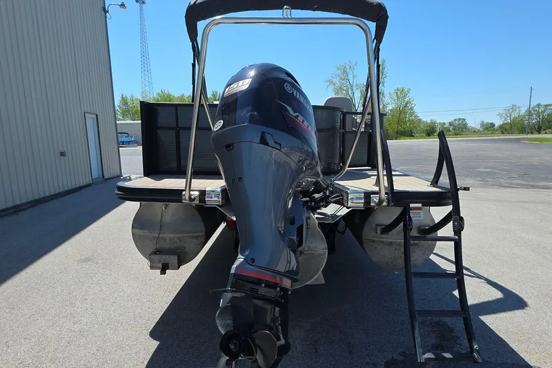 Slide: The Image of 2020 Bennington SX 22 SSLDX pontoon boat with Yamaha outboard motor, parked outdoors. - 5