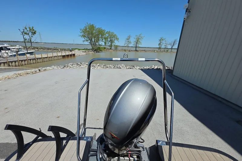 Slide: The Image of 2020 Bennington SX 22 SSLDX pontoon boat with outboard motor near a lakeside dock. - 7