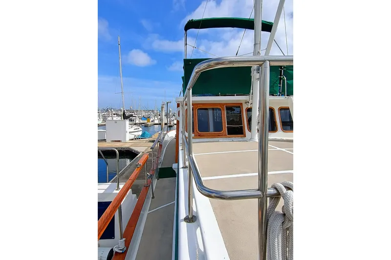 Slide: The Image of 1978 Californian LRC yacht docked at marina, featuring polished railings and wooden accents. - 12