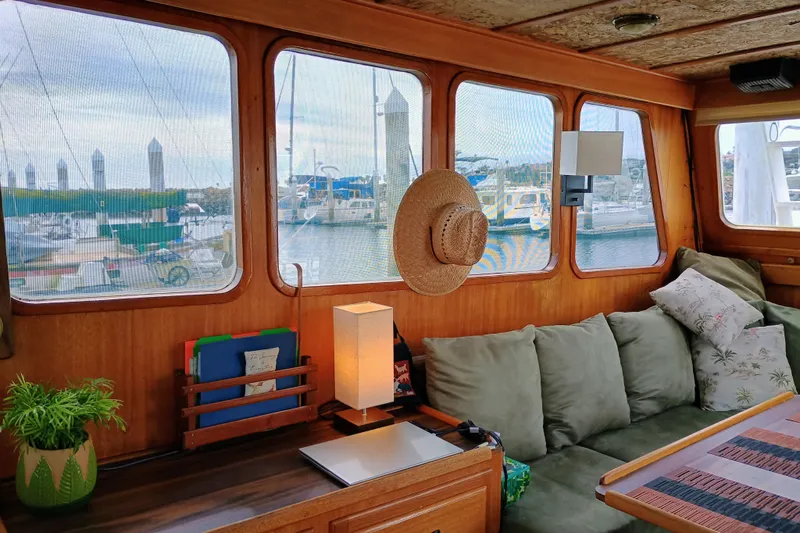 Slide: The Image of Interior of a 1978 Californian LRC boat with cozy seating and marina view. - 18