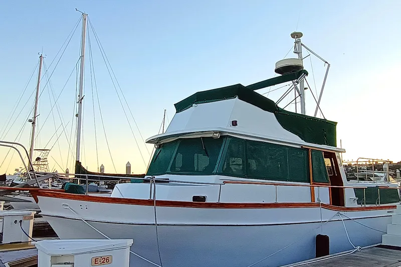 Slide: The Image of 1978 Californian LRC yacht docked at marina during sunset. - 2