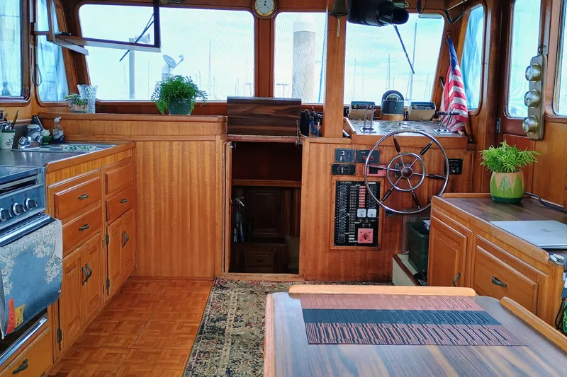 Slide: The Image of 1978 Californian LRC boat interior with wooden cabinetry, steering wheel, and American flag. - 20