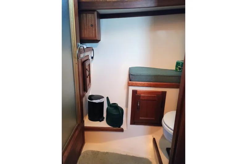Slide: The Image of 1978 Californian LRC boat interior with wooden cabinets and cushioned seating. - 23