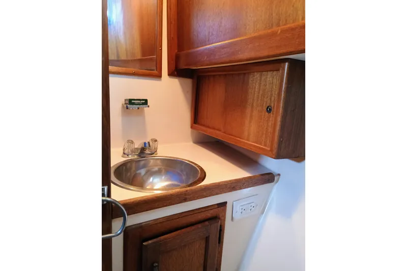 Slide: The Image of 1978 Californian LRC boat bathroom with wooden cabinets and stainless steel sink. - 25