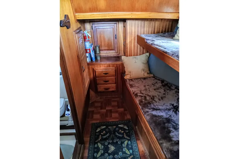 Slide: The Image of 1978 Californian LRC cabin interior with wooden bunk beds and storage. - 27