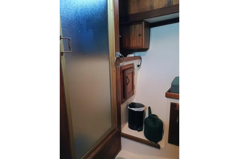 Slide: The Image of 1978 Californian LRC interior with wooden cabinets and frosted glass door. - 28
