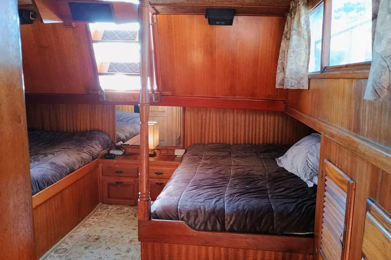 Slide: The Image of Cozy 1978 Californian LRC boat cabin with wooden interior and twin beds. - 32