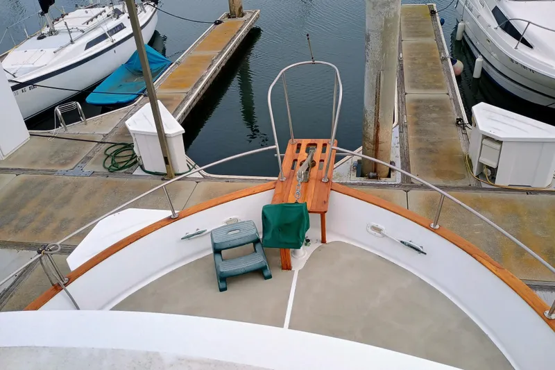 Slide: The Image of 1978 Californian LRC yacht docked at marina, featuring wooden deck and mooring equipment. - 4