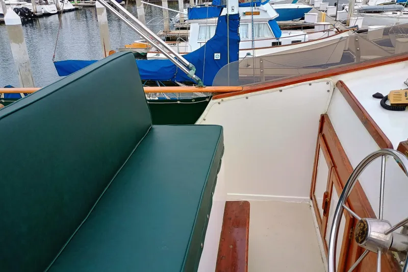 Slide: The Image of 1978 Californian LRC boat interior with green seating and wooden steering wheel. - 7