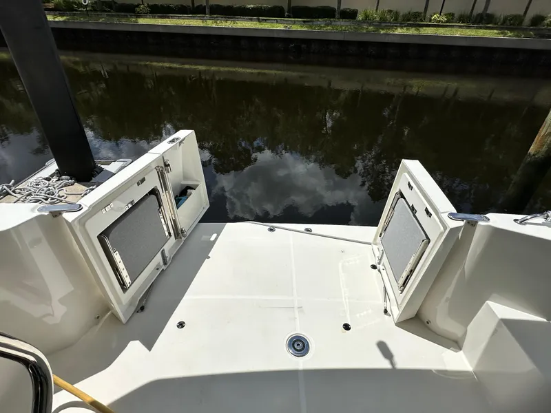 Slide: The Image of 2022 Beneteau Swift Trawler 35 stern view with open storage compartments. - 12