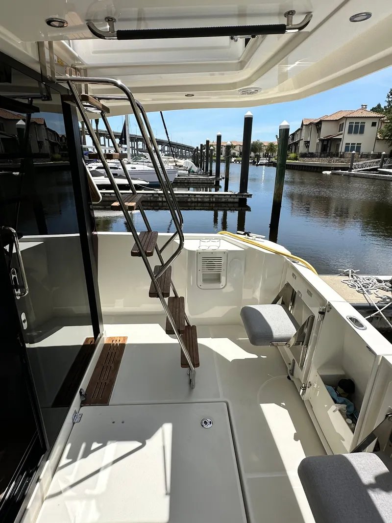 Slide: The Image of 2022 Beneteau Swift Trawler 35 deck with ladder, docked at marina. - 14
