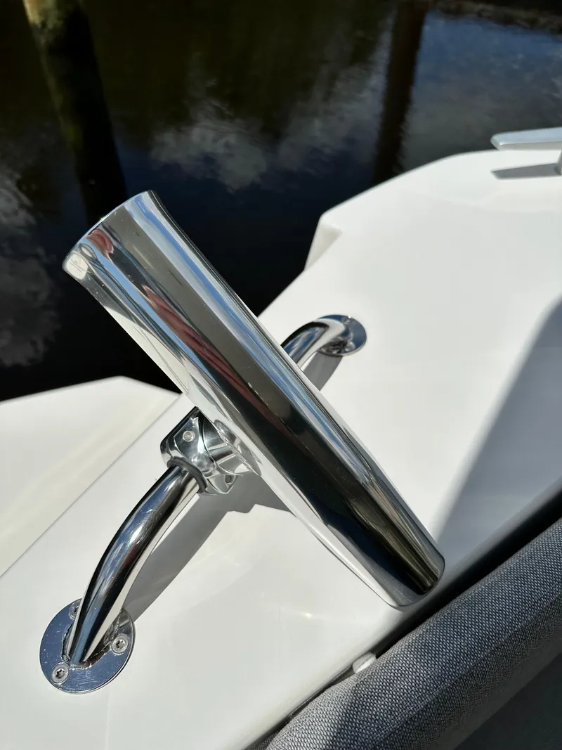 Slide: The Image of Close-up of a 2022 Beneteau Swift Trawler 35's polished metal cleat on deck. - 16
