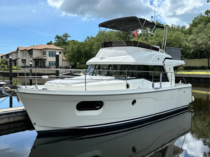 Slide: The Image of 2022 Beneteau Swift Trawler 35 docked, showcasing sleek design and modern features. - 2