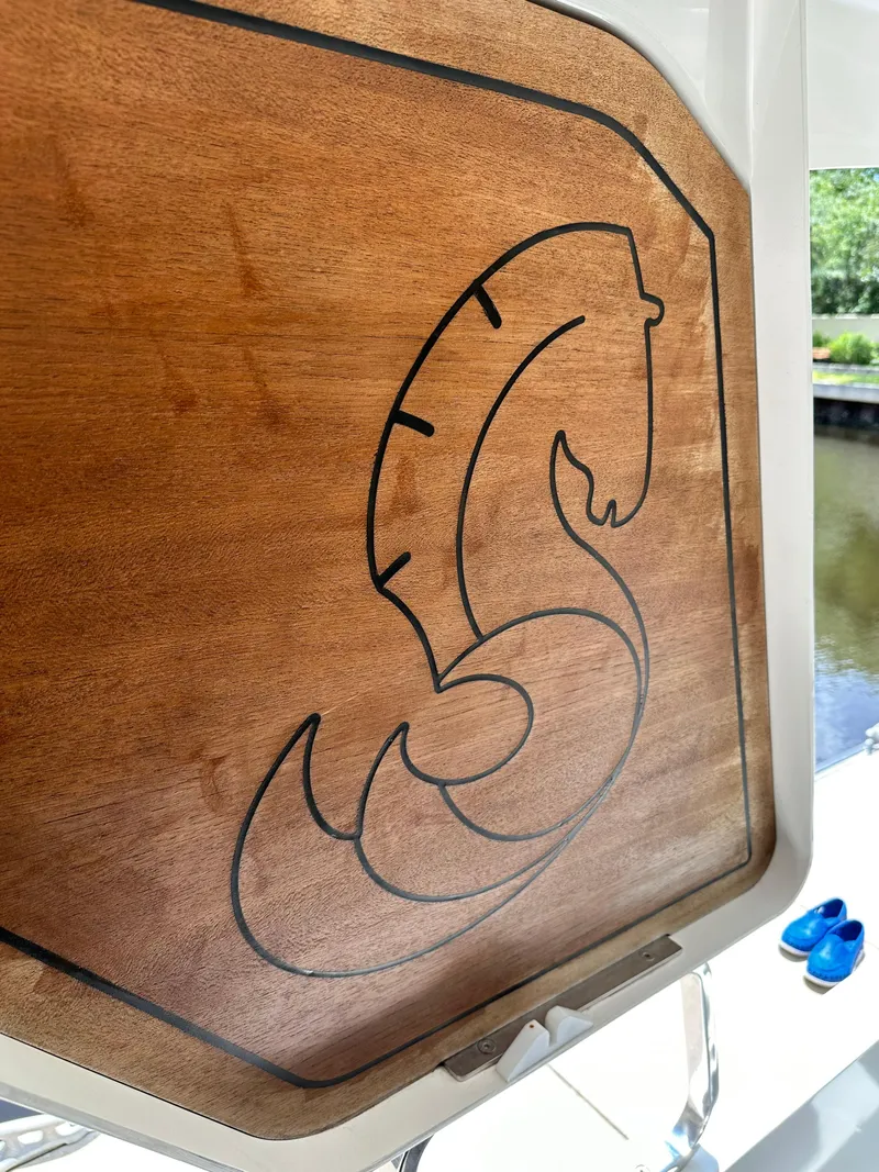 Slide: The Image of Wooden panel with engraved seahorse logo on 2022 Beneteau Swift Trawler 35. - 20
