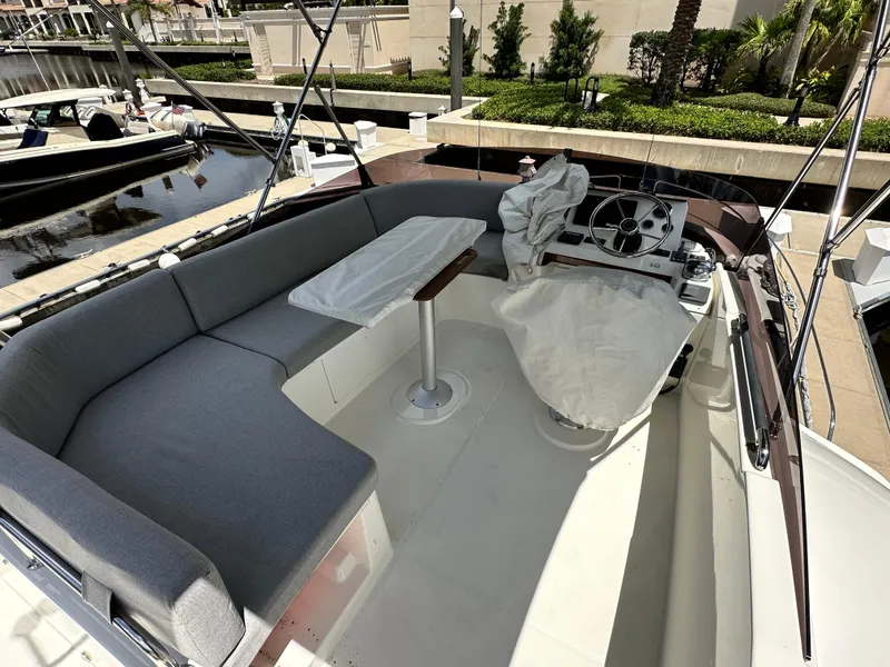 Slide: The Image of 2022 Beneteau Swift Trawler 35 flybridge with seating and helm, docked at marina. - 29