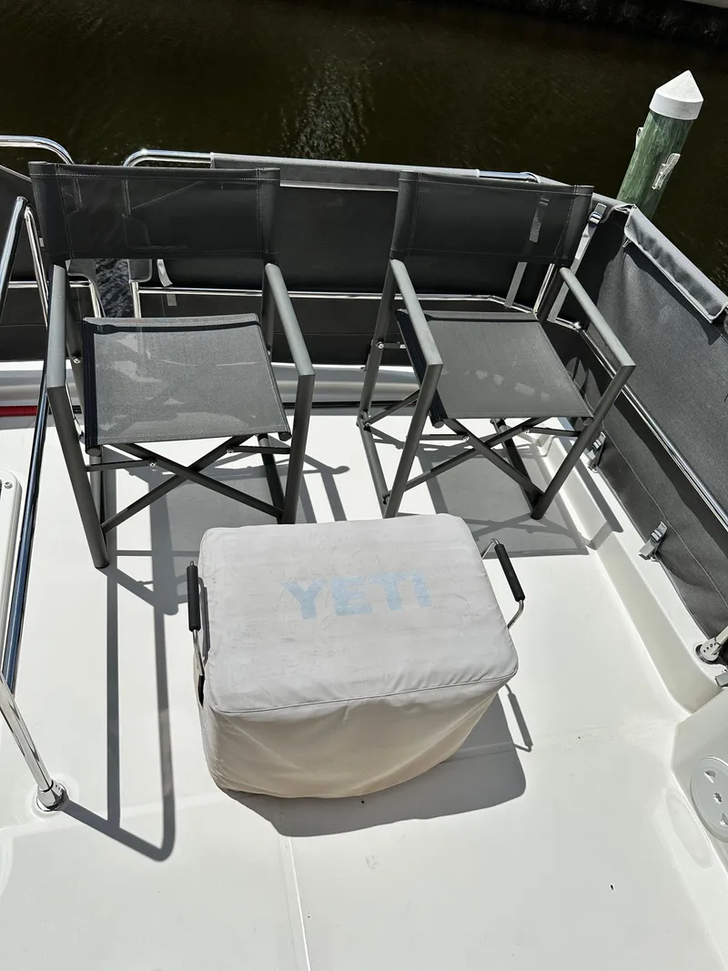 Slide: The Image of Deck of 2022 Beneteau Swift Trawler 35 with chairs and Yeti cooler. - 37