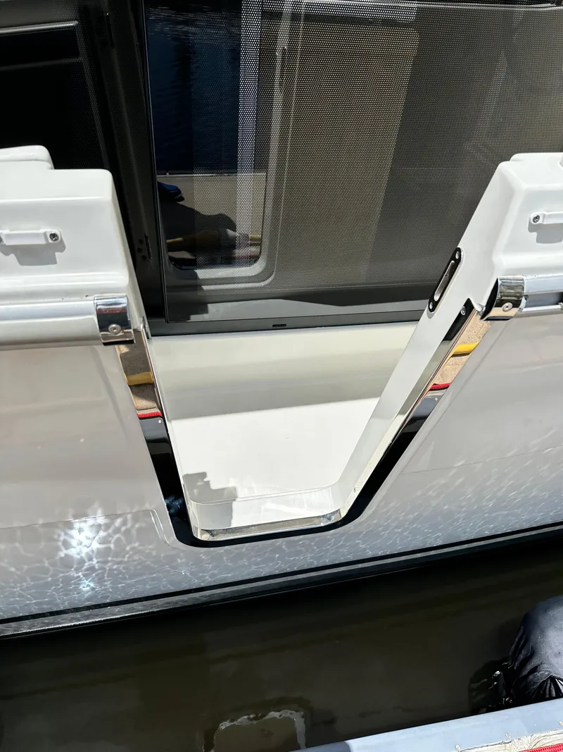 Slide: The Image of 2022 Beneteau Swift Trawler 35, open side gate, reflecting water. - 39