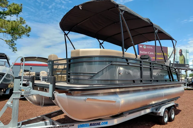 The Image of 2026 Starcraft EXS 3 Q DH pontoon boat on trailer, featuring a sleek design and canopy. - 1