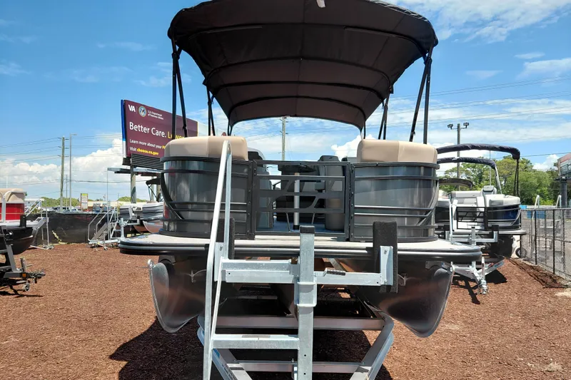 Slide: The Image of 2026 Starcraft EXS 3 Q DH pontoon boat displayed outdoors under a clear blue sky. - 10