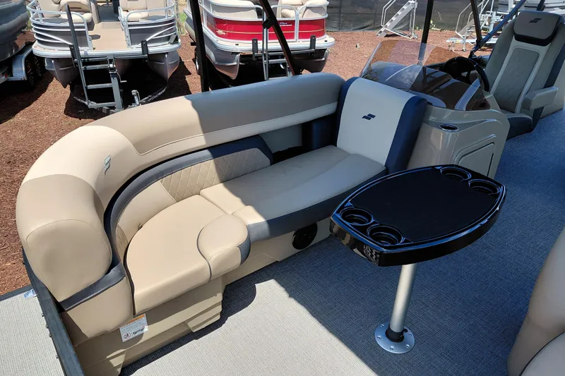 Slide: The Image of Luxurious seating area on 2026 Starcraft EXS 3 Q DH boat with table and cup holders. - 12