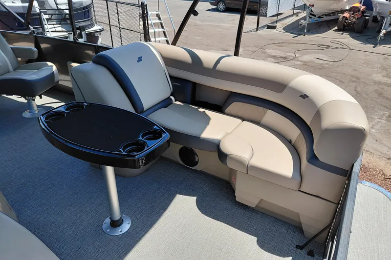 Slide: The Image of Luxurious seating area on 2026 Starcraft EXS 3 Q DH boat with cupholder table. - 13