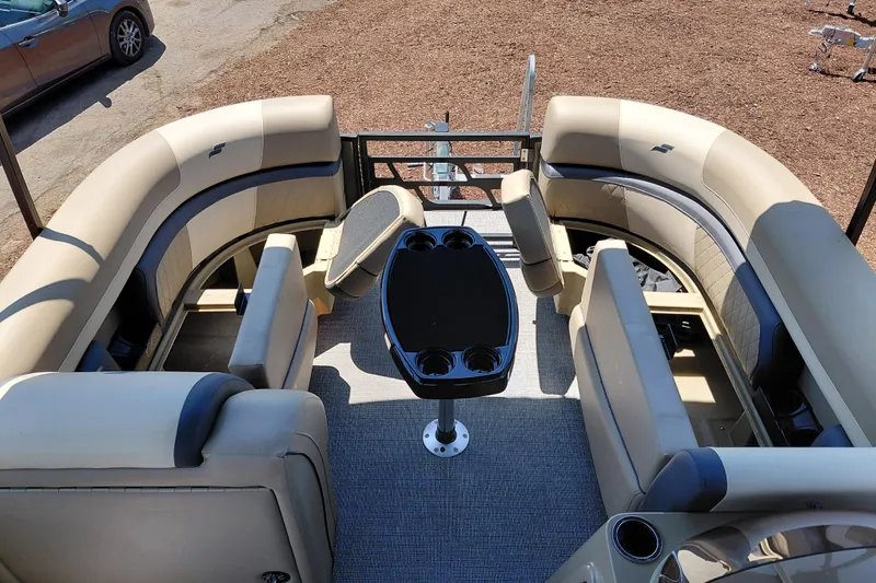 Slide: The Image of Luxurious seating area on 2026 Starcraft EXS 3 Q DH pontoon boat with table and cup holders. - 16