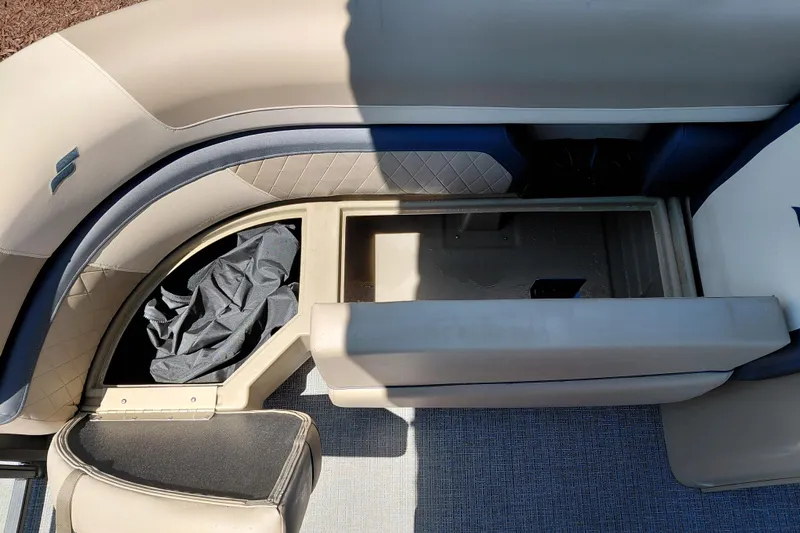 Slide: The Image of 2026 Starcraft EXS 3 Q DH boat interior with storage compartment and seating. - 18