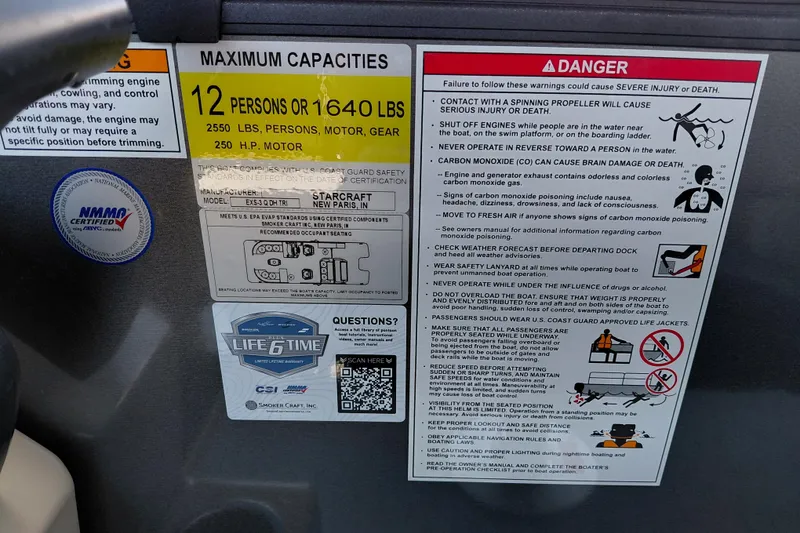 Slide: The Image of Warning and capacity labels on a 2026 Starcraft EXS 3 Q DH boat. - 22