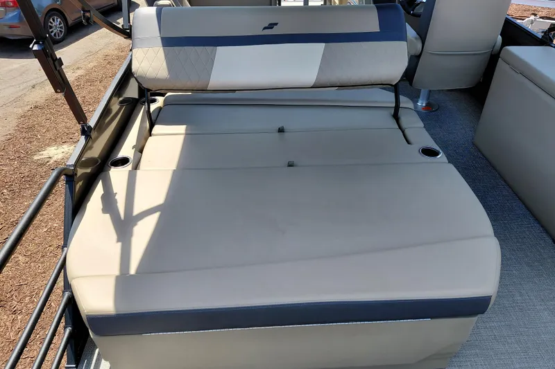 Slide: The Image of 2026 Starcraft EXS 3 Q DH boat interior with beige seating and cup holders. - 32