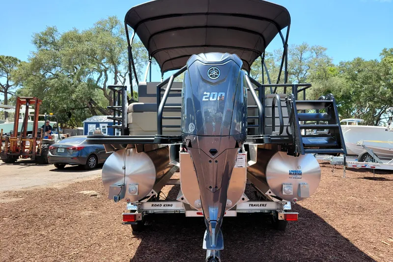 Slide: The Image of 2026 Starcraft EXS 3 Q DH pontoon boat with Yamaha 200 engine on trailer. - 4