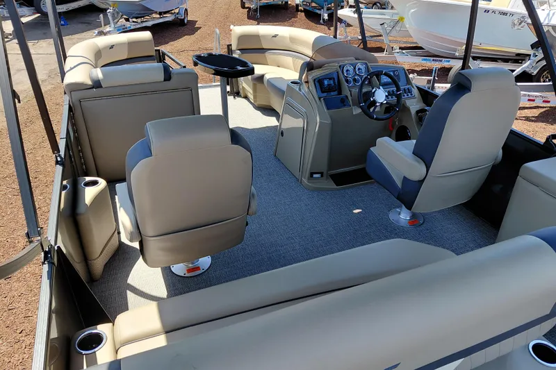 Slide: The Image of Interior of 2026 Starcraft EXS 3 Q DH pontoon boat with beige seating and modern dashboard. - 40
