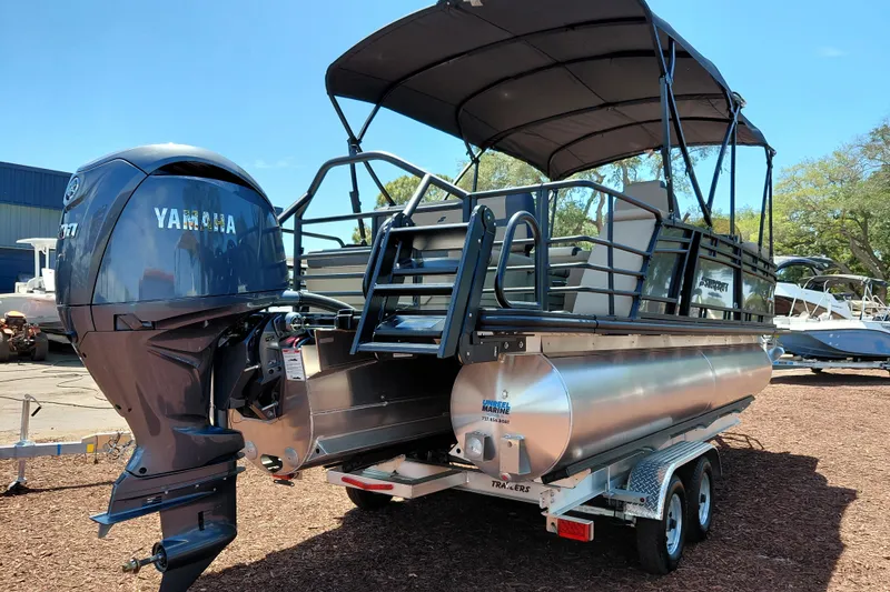 Slide: The Image of 2026 Starcraft EXS 3 Q DH pontoon boat with Yamaha engine on trailer. - 5