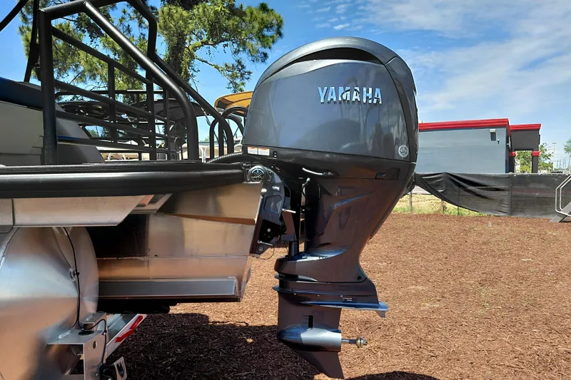 Slide: The Image of 2026 Starcraft EXS 3 Q DH boat with Yamaha outboard motor, parked outdoors. - 7