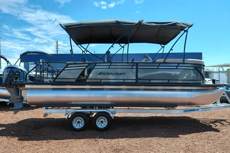 Slide: The Image of 2026 Starcraft EXS 3 Q DH pontoon boat with canopy on trailer, side view. - 8