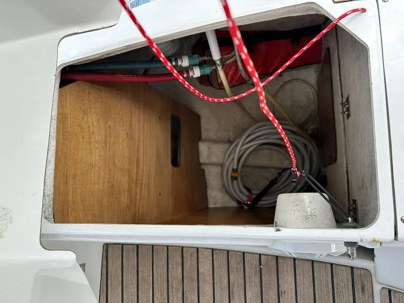 Slide: The Image of Storage compartment on 2011 Jeanneau Sun Odyssey 45 DS sailboat with ropes and hoses. - 28