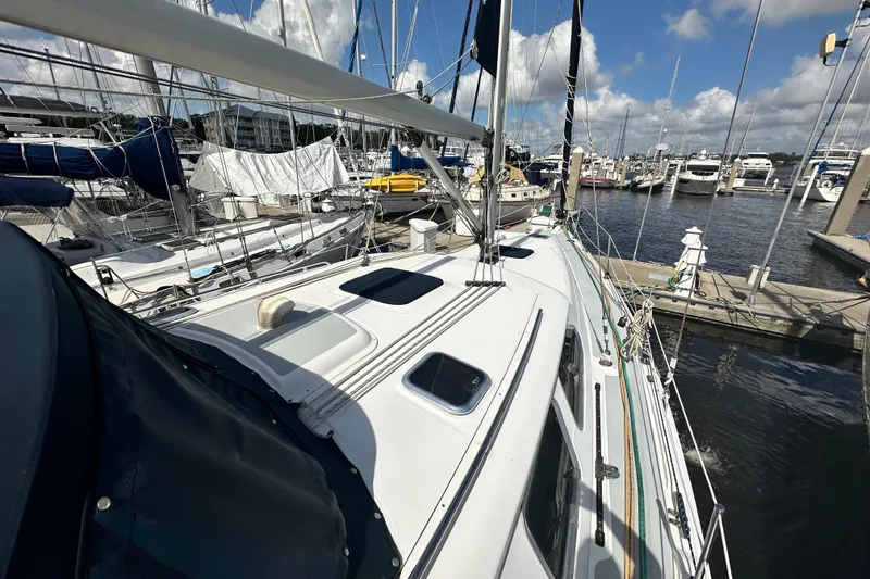 Slide: The Image of 2006 Hunter 41 Deck Salon sailboat docked at marina under blue sky. - 17