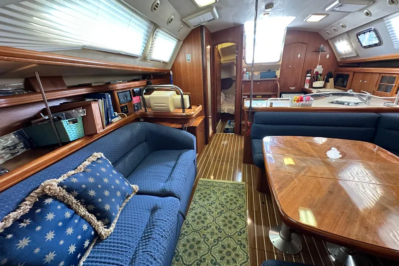 Slide: The Image of Interior of 2006 Hunter 41 Deck Salon yacht with cozy seating and wooden finishes. - 63